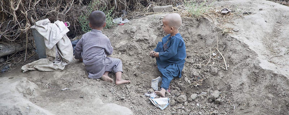 Two boys playing in dirt
