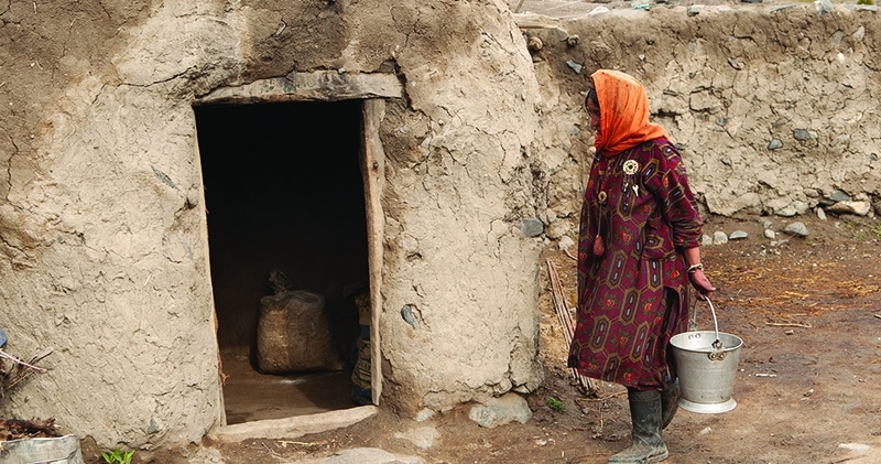 Girl walking into traditional home in Central Asia