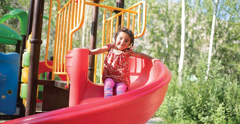 Girl on playground slide