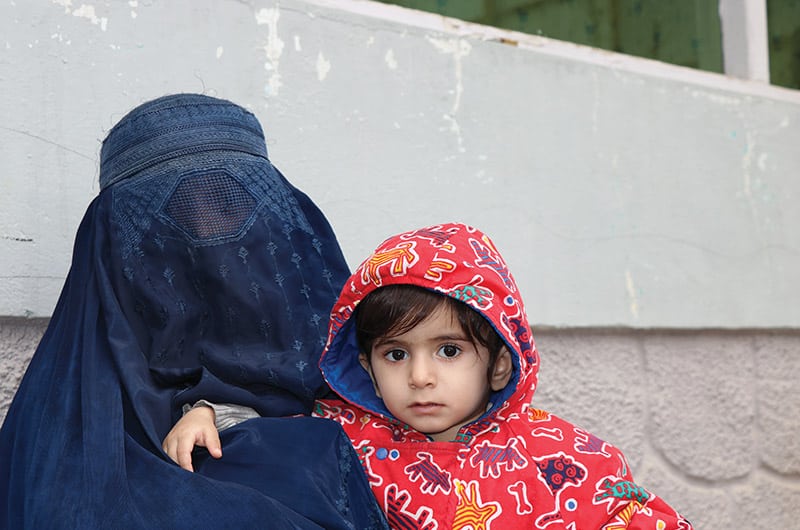 woman in burqa with young child