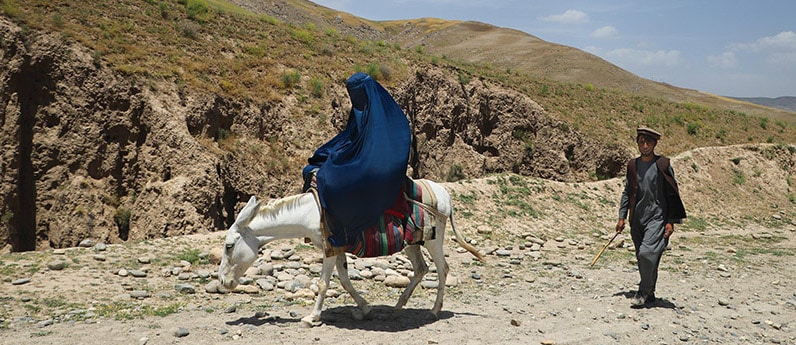 woman on donkey in Afghanistan