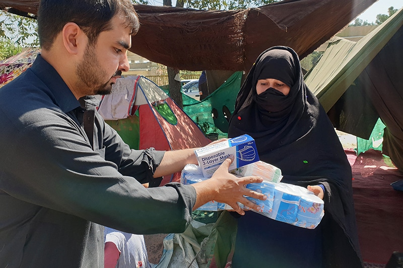 Aid worker handing out supplies