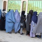 Women standing in line for aid packages