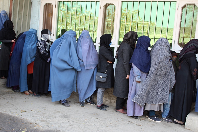 Women standing in line for aid packages