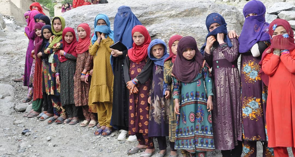 Afghan girls and women standing in line