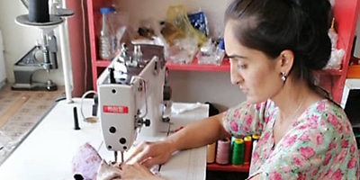 Fakhryia - woman at sewing machine