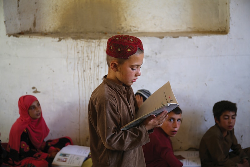 6-year-old Ahmad at the CBE school in Kata Sang village, Mussahi District, Kabul Province, Afghanistan. The teacher’s name is Mohammad Gul.  The school is located inside a mosque compound.