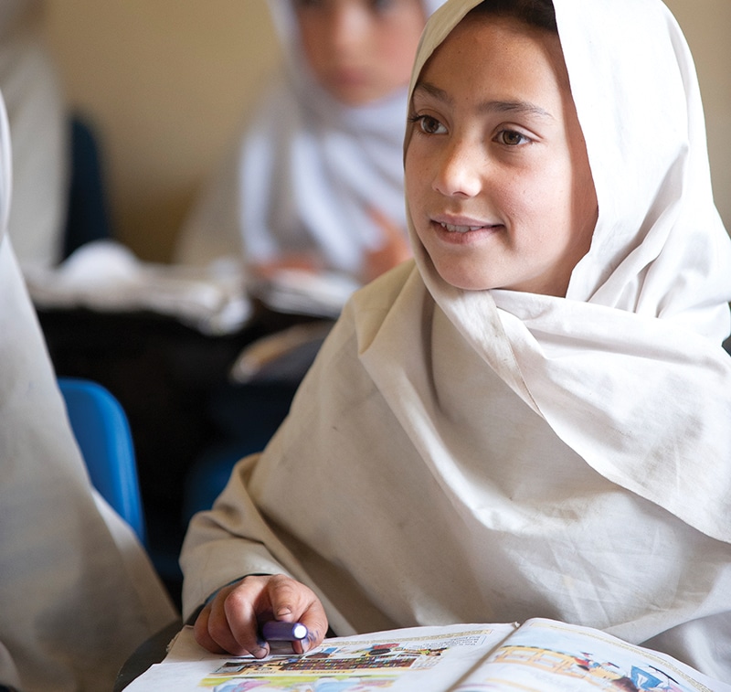 Smiling girl in classroom in Pakistan