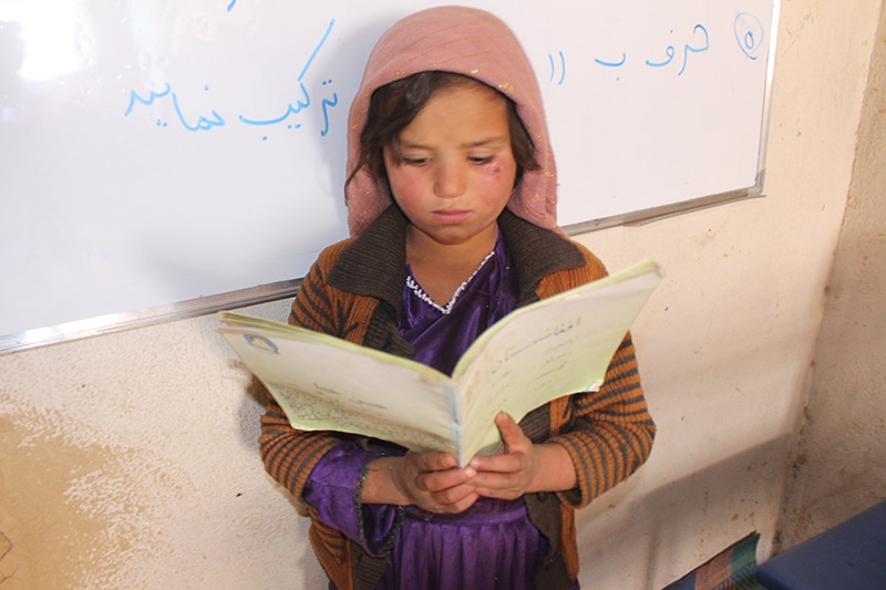Afghan girl reading a book