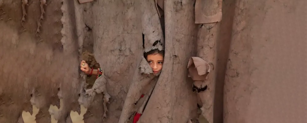 Afghans peering through curtain