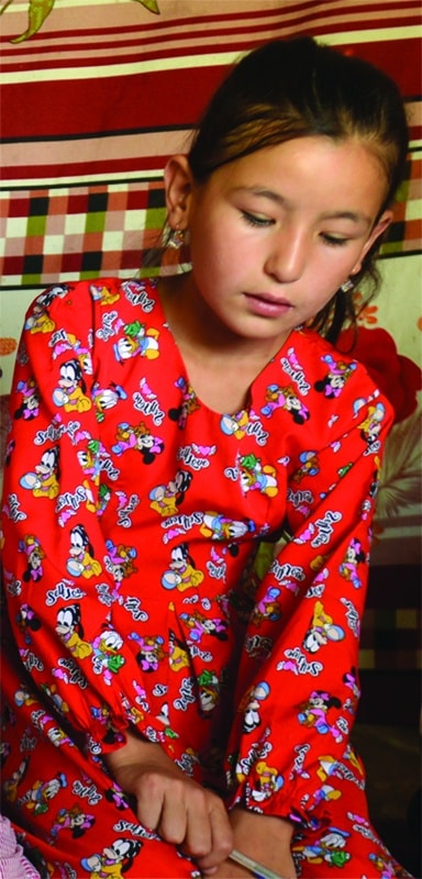 student in red dress reading