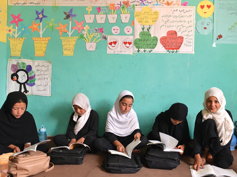 Afghan students sitting on the floor