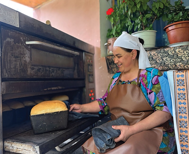Woman baking bread in Tajikistan