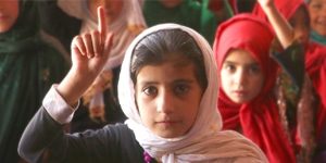 Afghan student raising hand in classroom