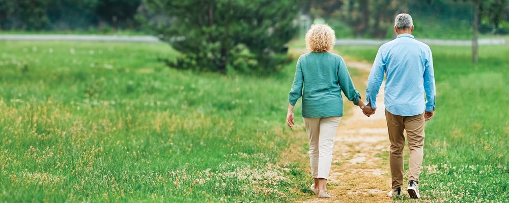 Two people walking holding hands